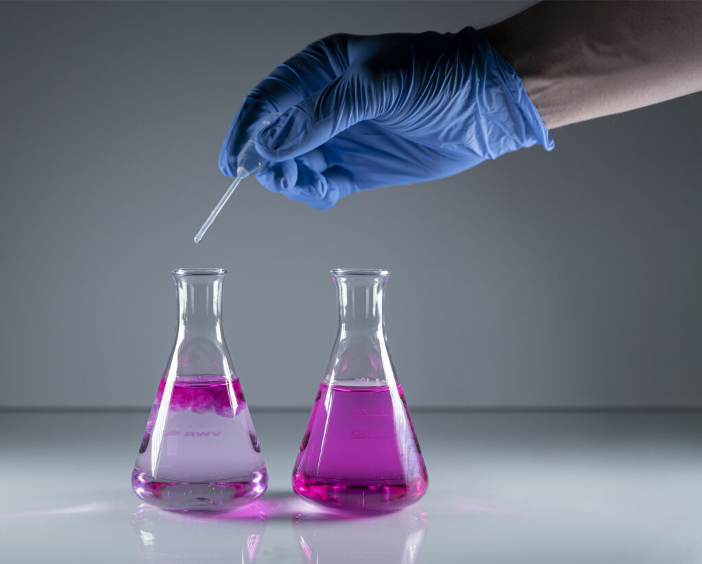 مواد موجودة في كثير من مرطبات البشرة لا أحد سيخبرك بمدى خطورتها على بشرتك 3 scientists hand with medical glove analyzing chemistry samples glass chemistry flasks 1